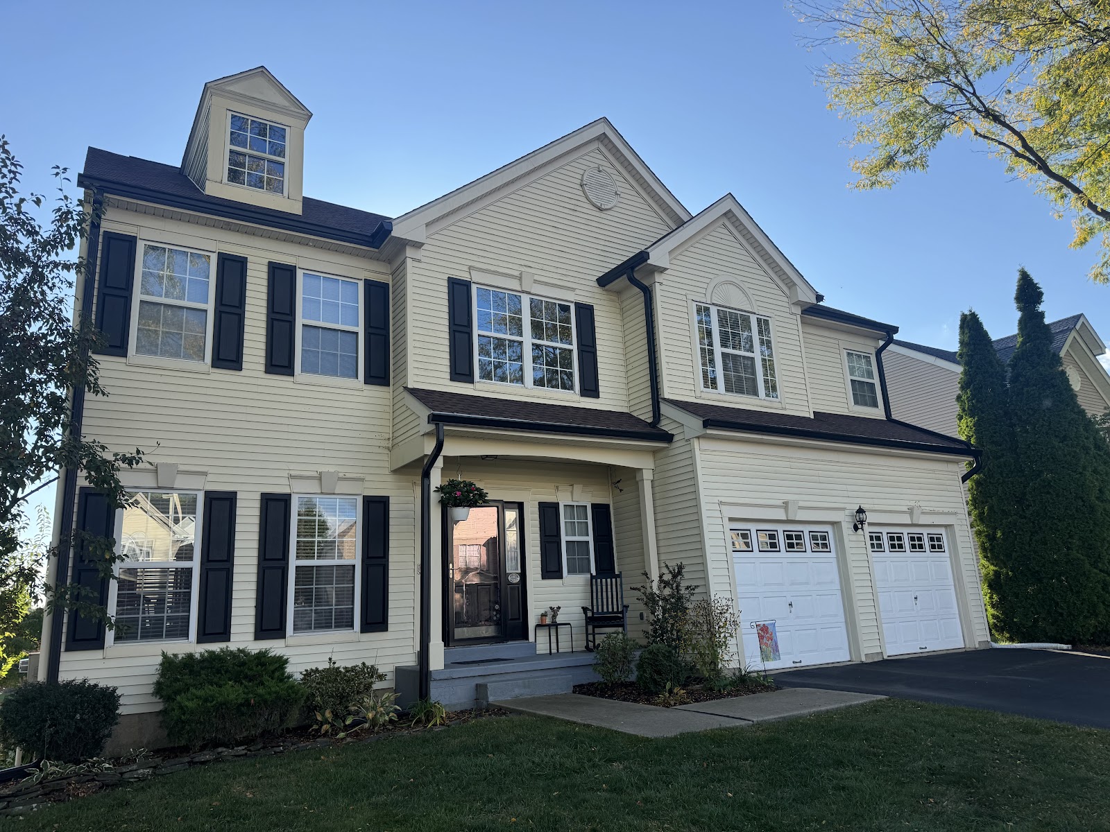 Two-story home with newly installed seamless gutters along the roofline