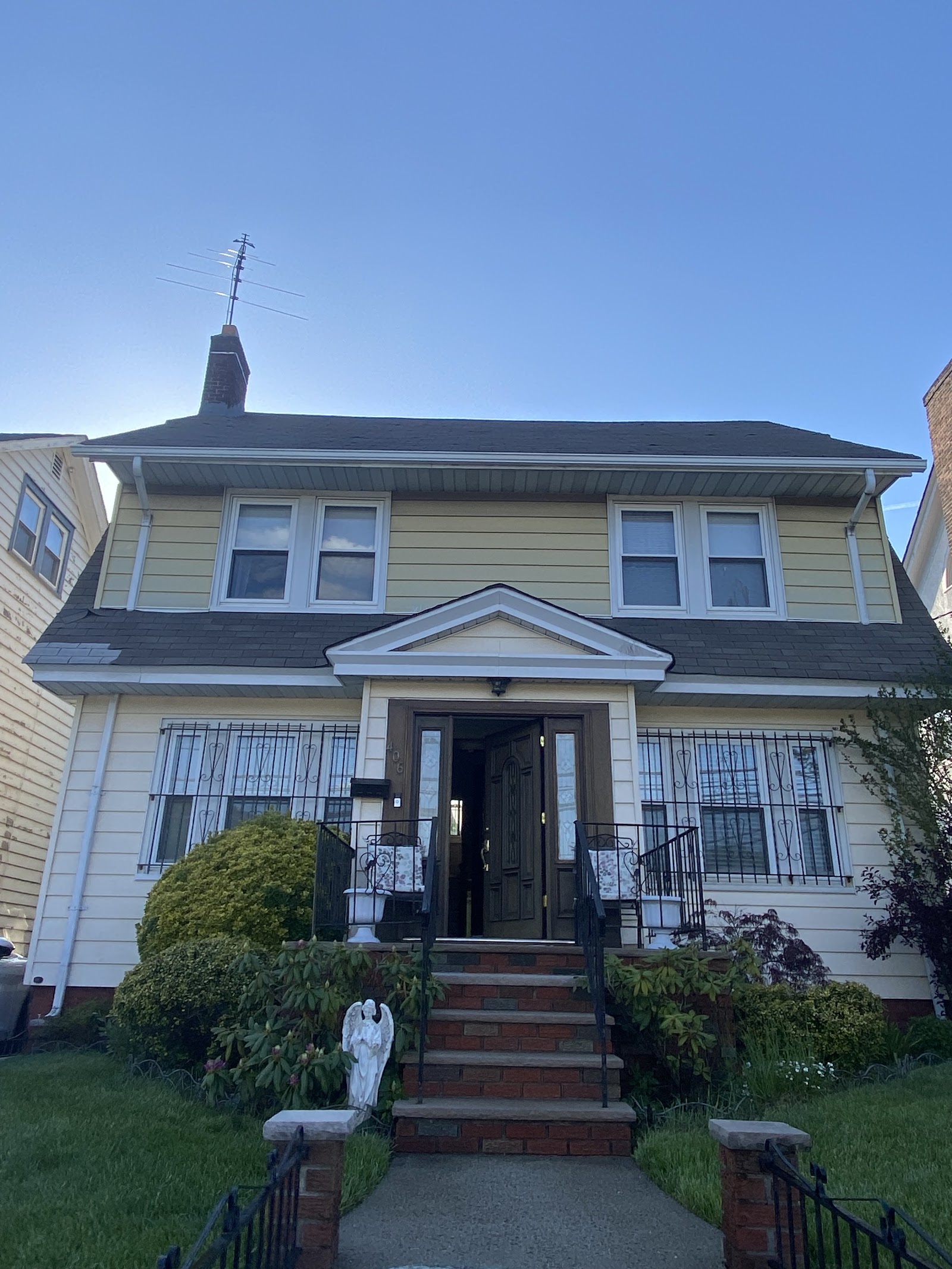 Front of a home with gutters running above the porch