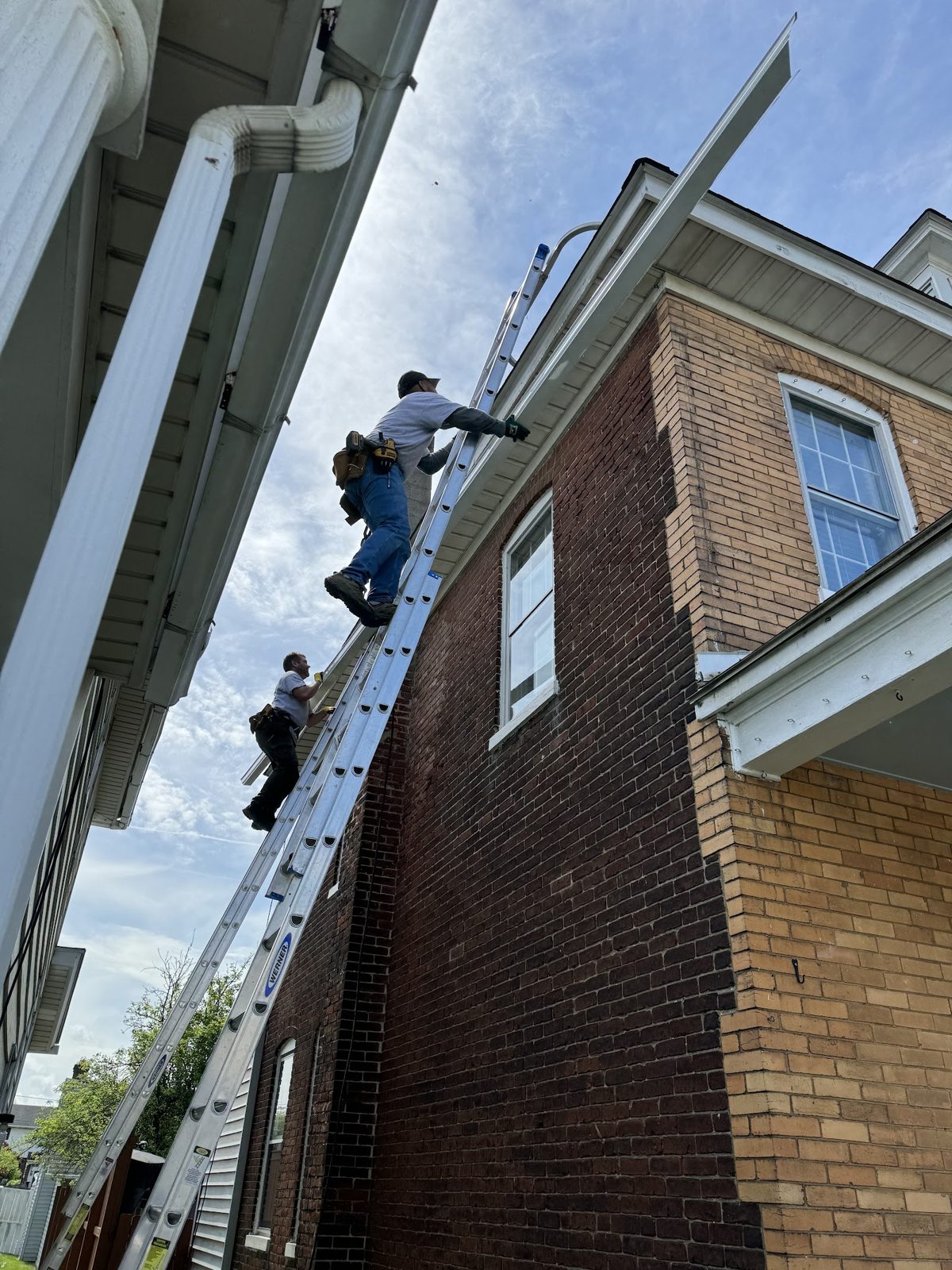 Loose gutter section being re-secured with a new hanger bracket